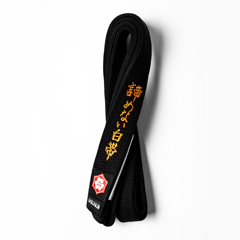 A WHITE BELT WHO NEVER QUIT EDITION — ORIGINAL black belt with white bar and orange embroidery
