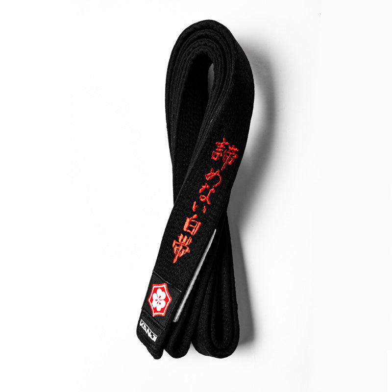 A WHITE BELT WHO NEVER QUIT EDITION — ORIGINAL black belt with white bar and red embroidery