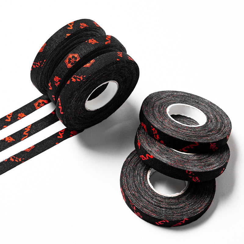 Stack of black KANJI premium finger tape rolls