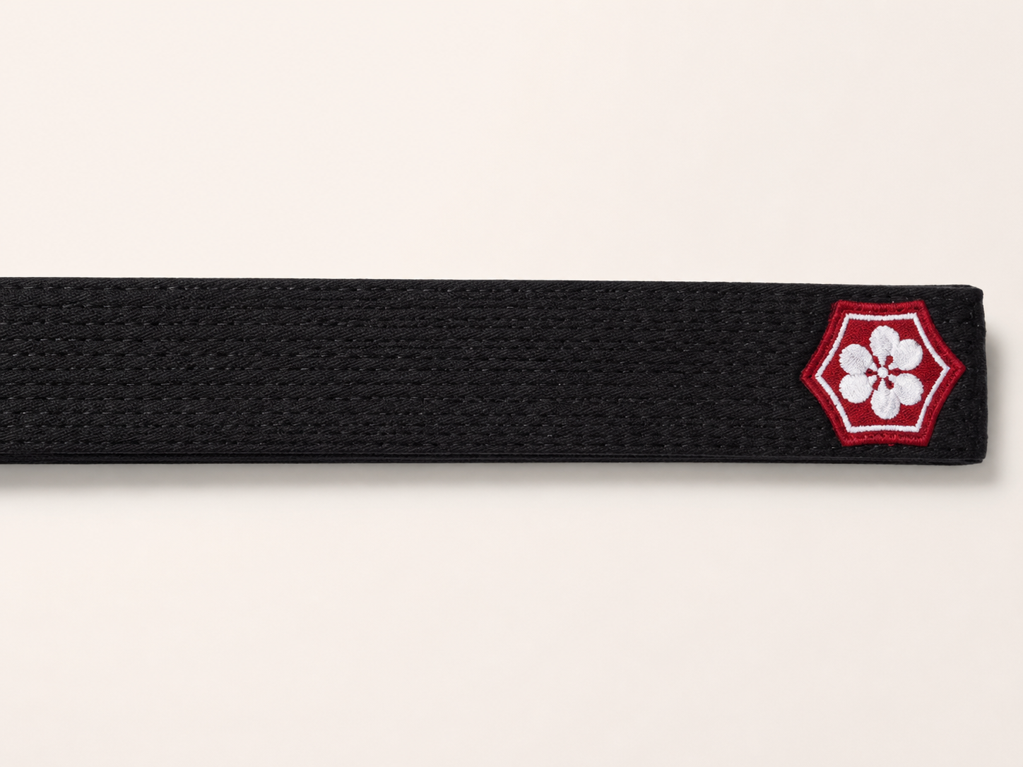 KANJI logo-side embroidery placement on a black BJJ belt