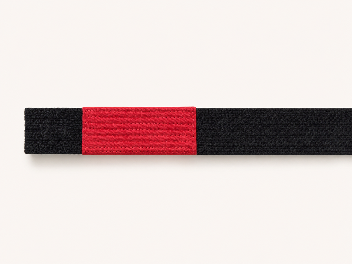 Rank-bar-side embroidery placement on a black BJJ belt